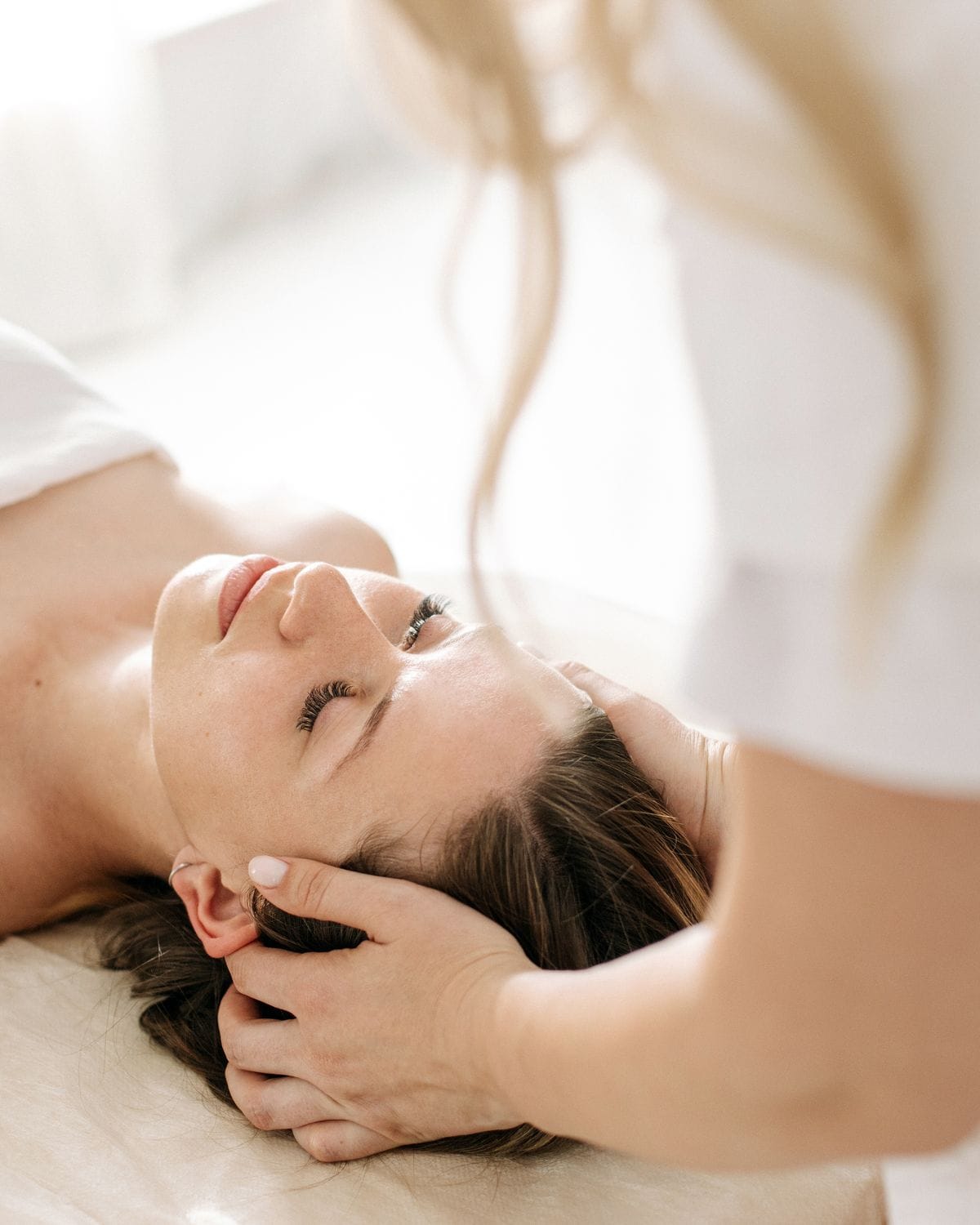 A guest receiving a calming head massage