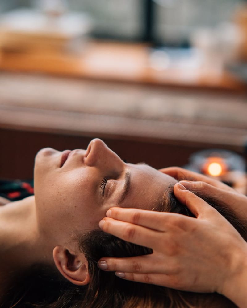 Therapist easing tension at the temples during the consult