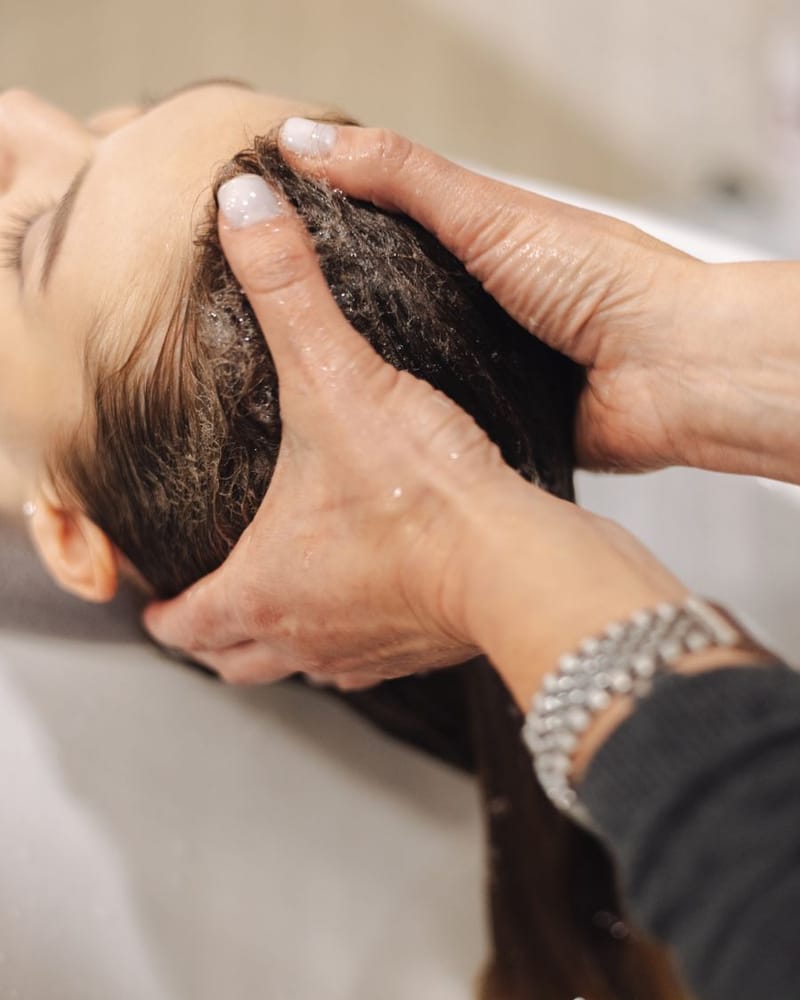Hands working through the scalp during a head spa treatment